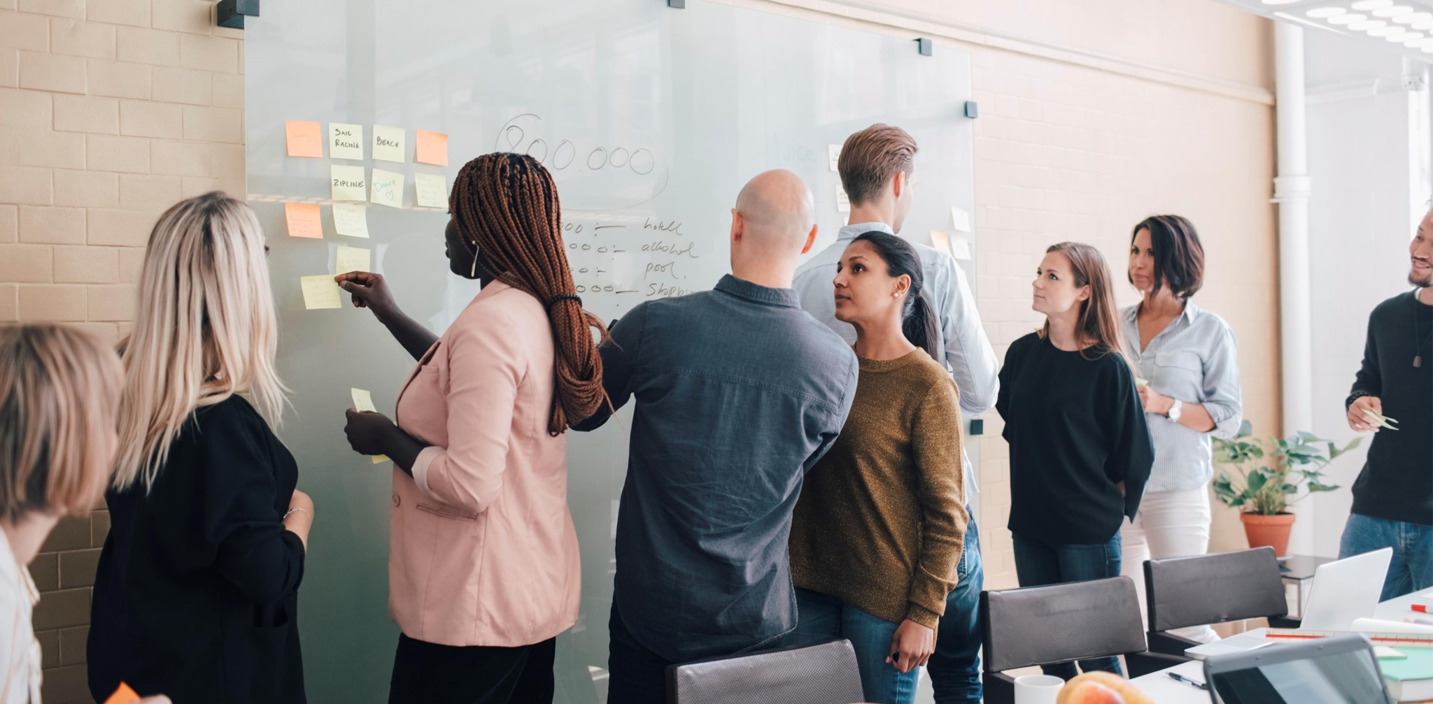 A diverse team working together at a workshop board